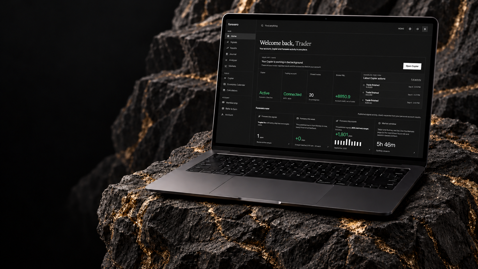 Forexero app on a MacBook in a charcoal stone setting with gold veins.